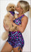 Girl wearing Pink Leopard set, holding her puppy in a matching Pink Leopard doggy bandana